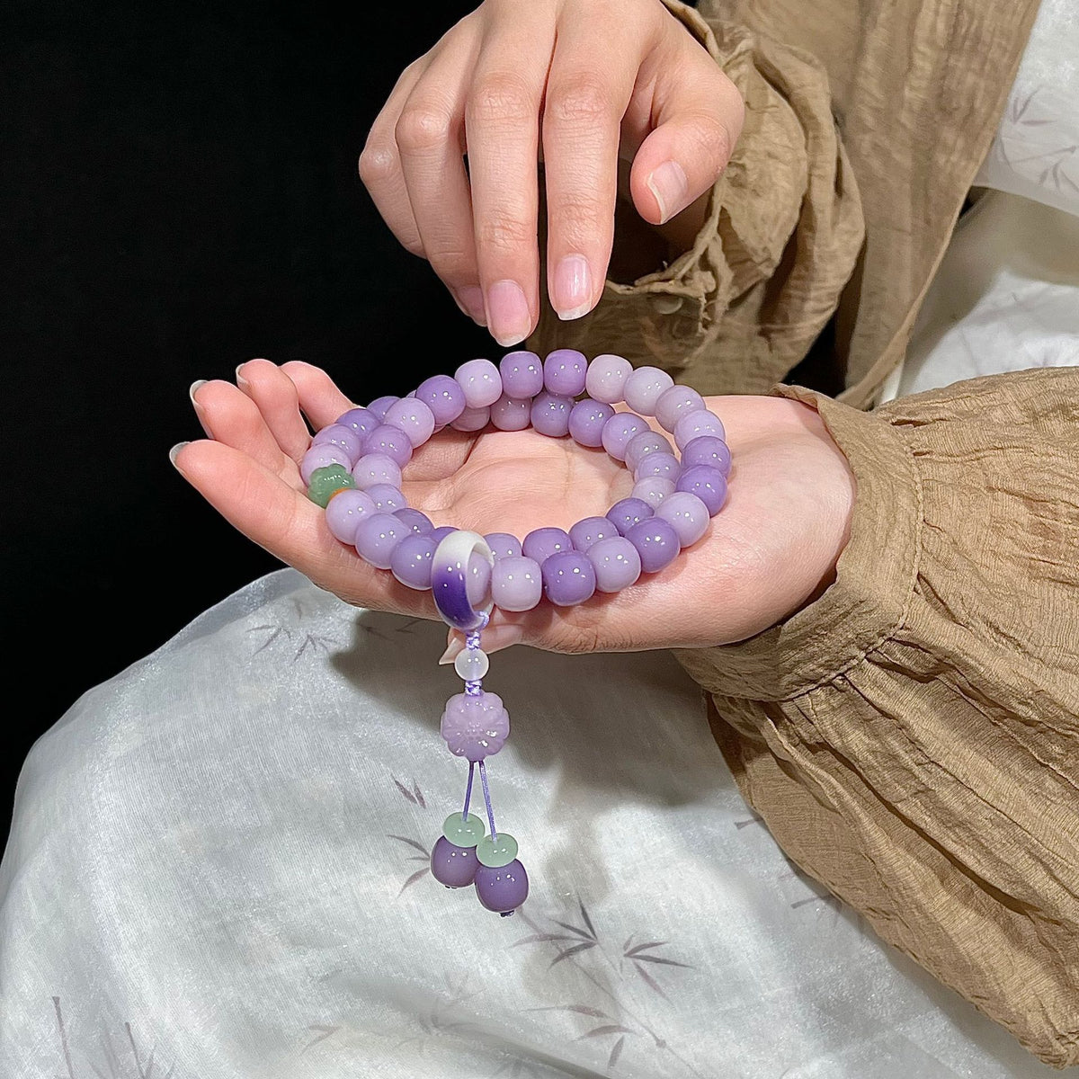 Lavender purple Bodhi root double-wrap bracelet and hand mala with floral tassel accents in a Neo-Chinese style