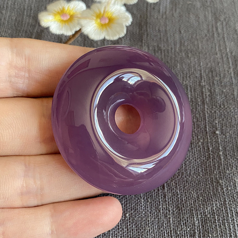 Large purple chalcedony donut pendant polished front view