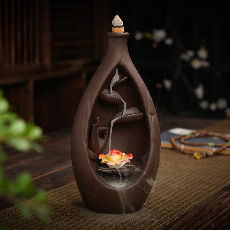 Purple clay bottle incense burner in tea-room setting with lotus and descending smoke
