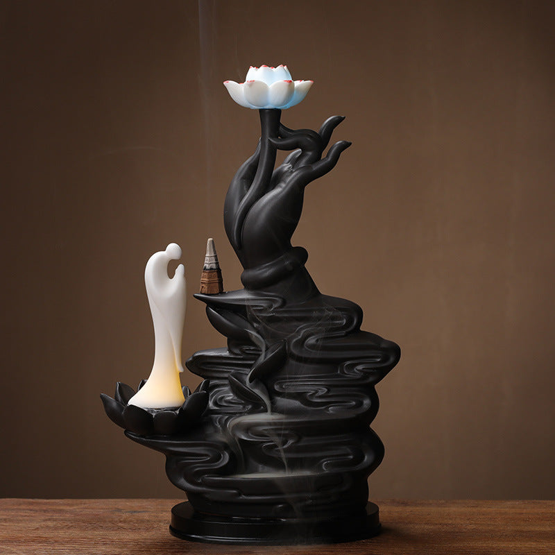 Black lotus hand backflow incense burner with layered smoke waterfall and white monk figure