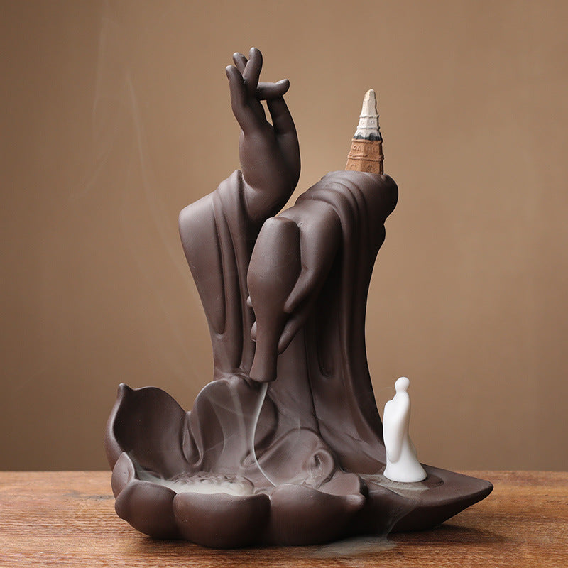 Brown mudra hand backflow incense burner with little monk and lotus basin