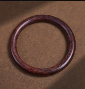 Purple zitan-style round wooden bangle bracelet with deep reddish-purple grain