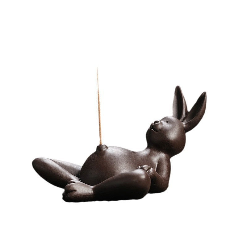 Reclining rabbit incense stick holder in dark ceramic finish