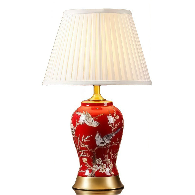Red bird floral ceramic lamp with pleated cream lampshade and brass-tone base