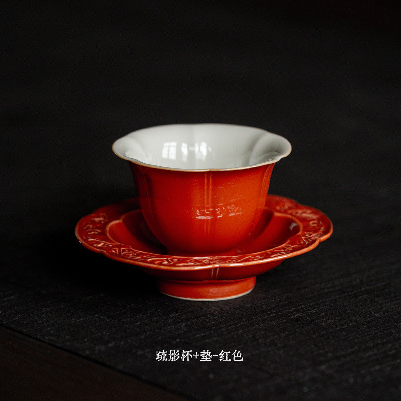 Red glazed flower form Chinese tea cup with saucer