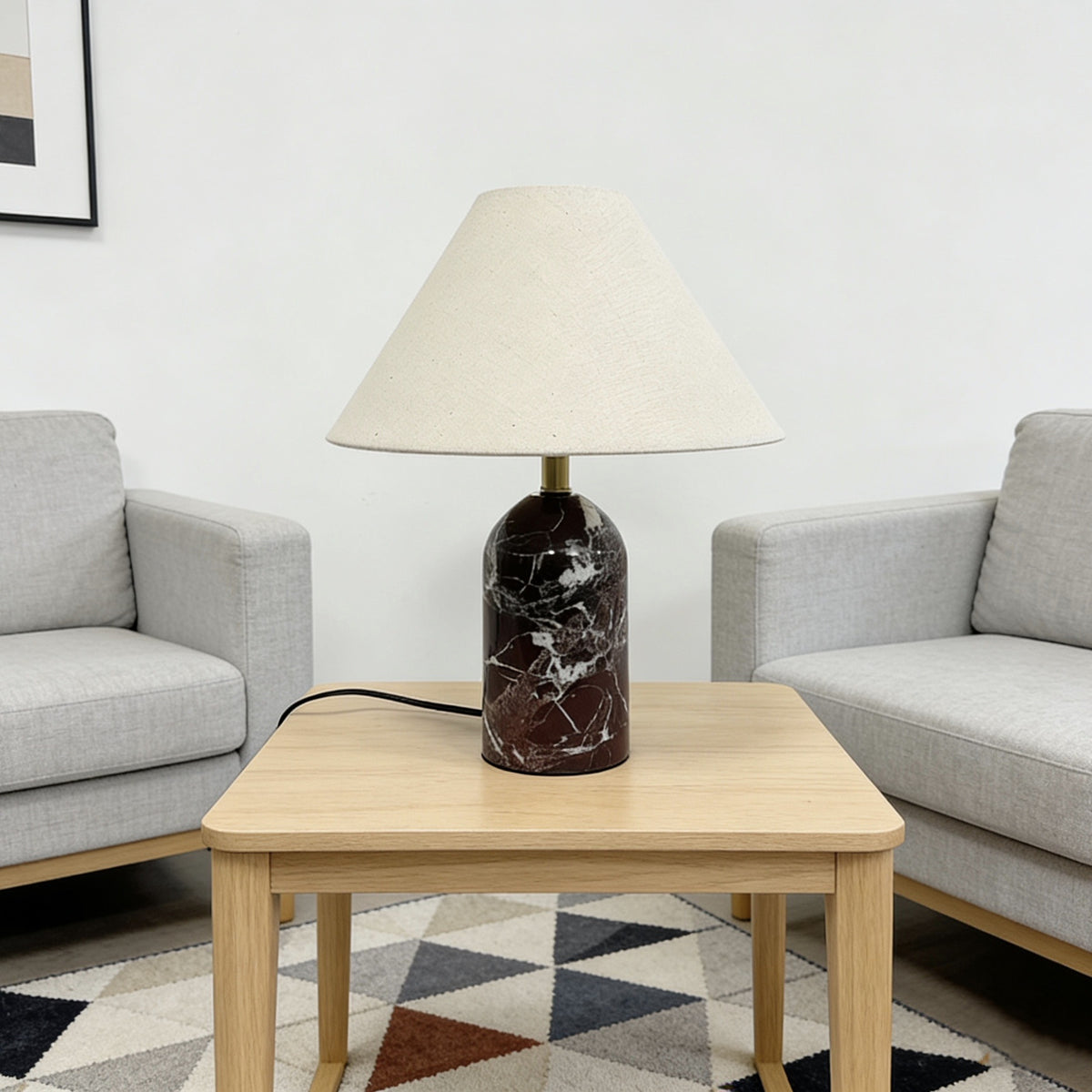 Red marble table lamp styled between modern armchairs