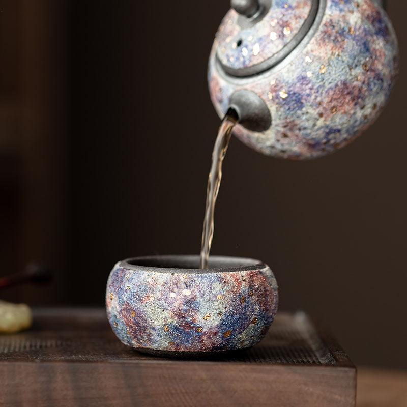 Rock mineral ceramic Gongfu tea cup shown during tea pouring