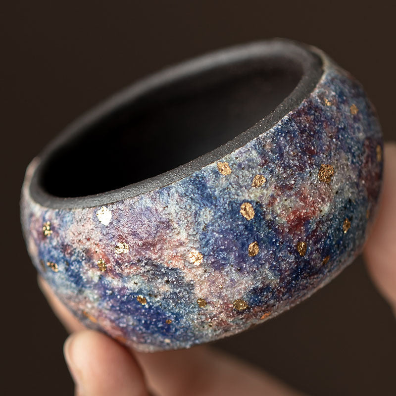 Detailed multicolor rock-mineral surface and gold speck decoration on ceramic tea cup