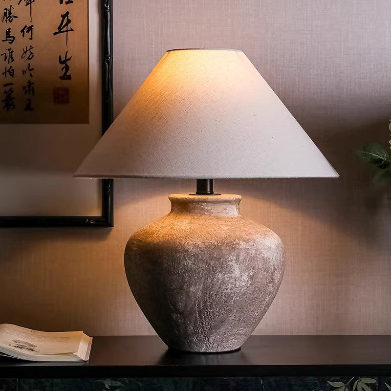 Rustic jar ceramic table lamp on dark wood console in Chinese-inspired interior