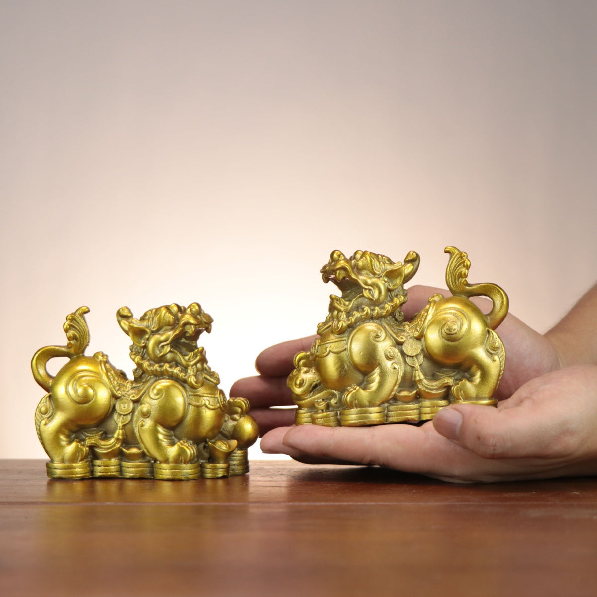 Ruyi Money Pixiu copperware pair shown in hand for scale, Chinese auspicious wealth beasts with coins and gourd details