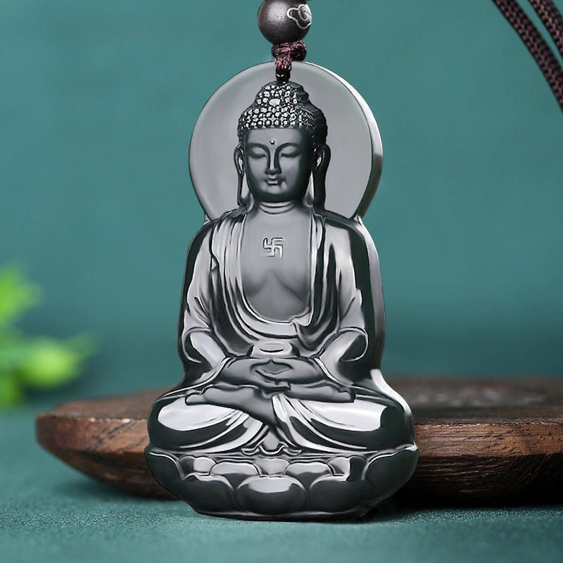 Dark charcoal Buddhist figure pendant with polished relief