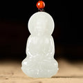 Ivory white carved seated Buddhist figure pendant front view