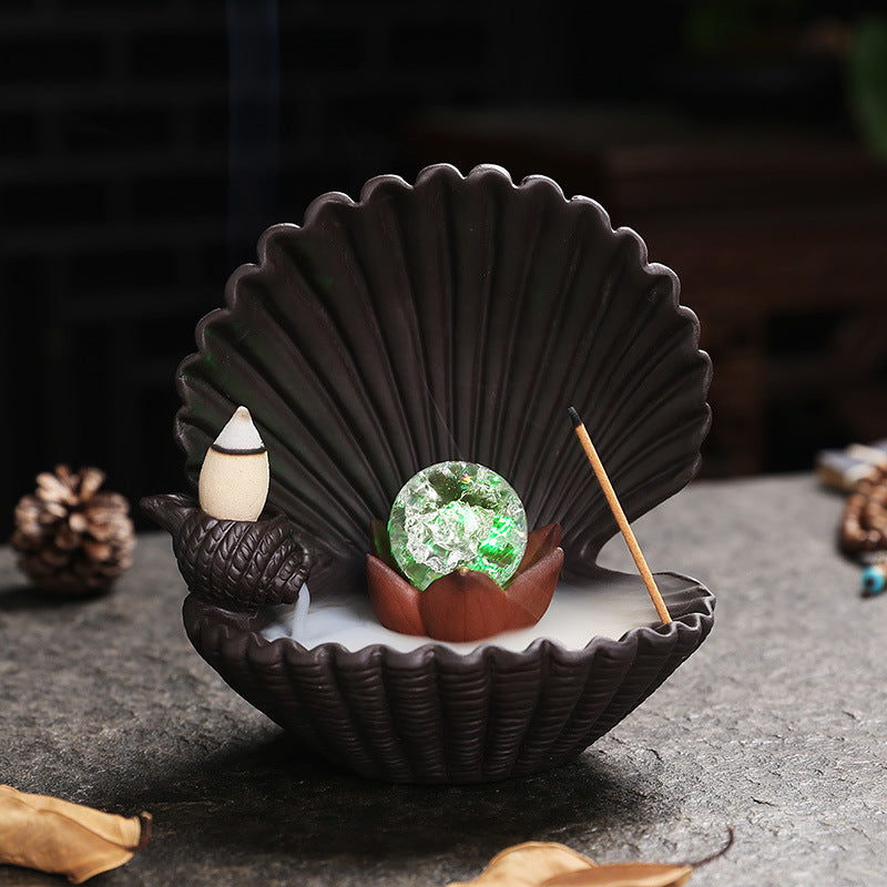 Shell-shaped incense burner with illuminated crystal-style orb, backflow cone and incense stick