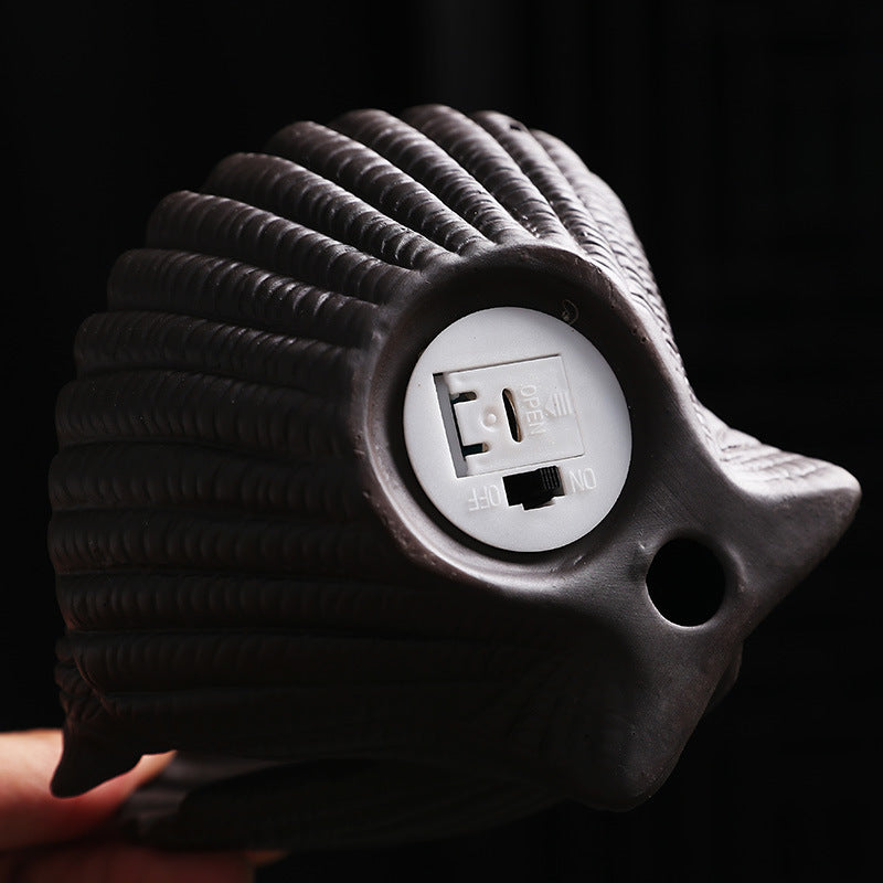 Rear battery and switch compartment of shell-shaped illuminated incense burner