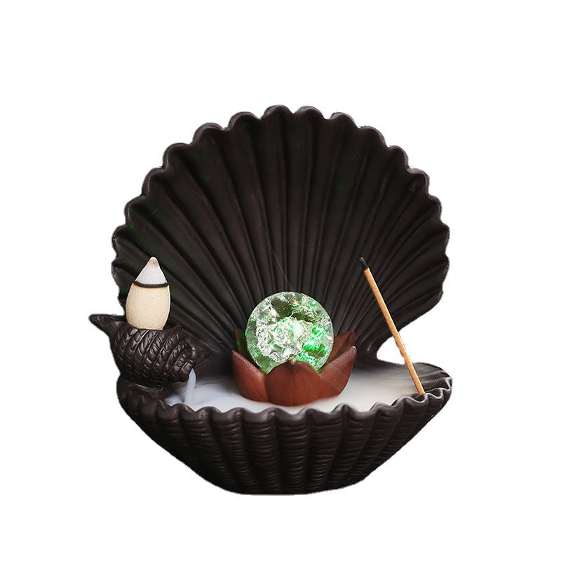 Shell incense burner cutout with glowing orb, backflow cone and stick incense holder