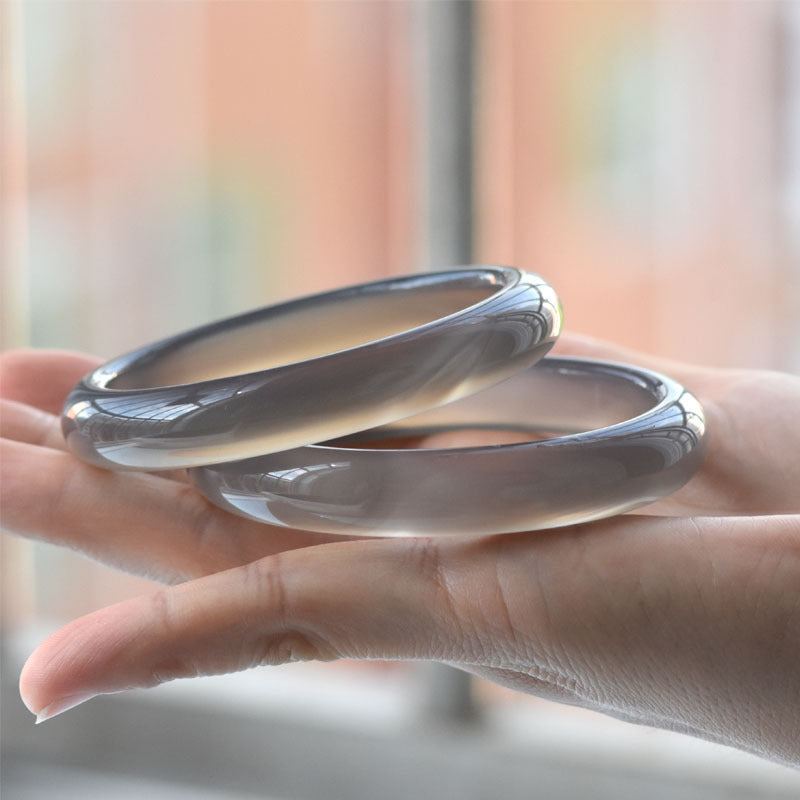 Certified smoky gray chalcedony bangle pair with translucent polished finish