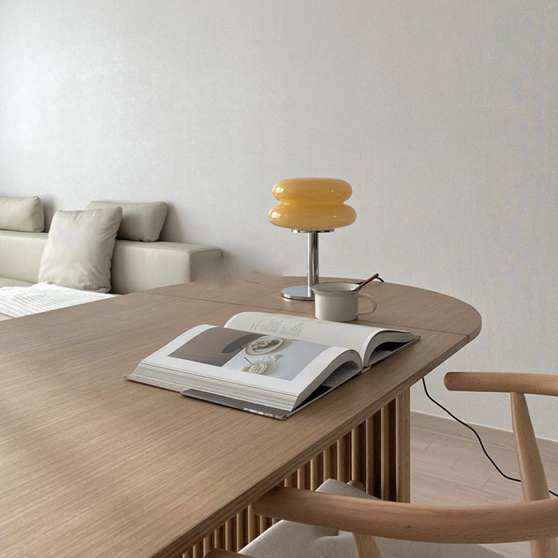 Milk yellow stacked glass cake lamp styled on modern dining table