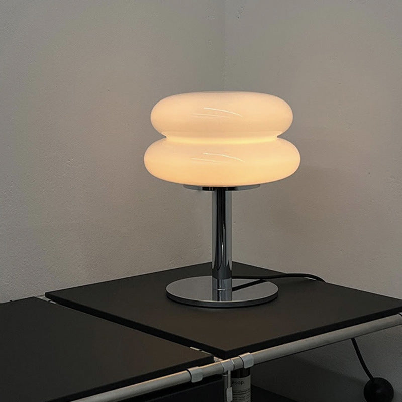 Warm glowing stacked glass cake table lamp with chrome pedestal base
