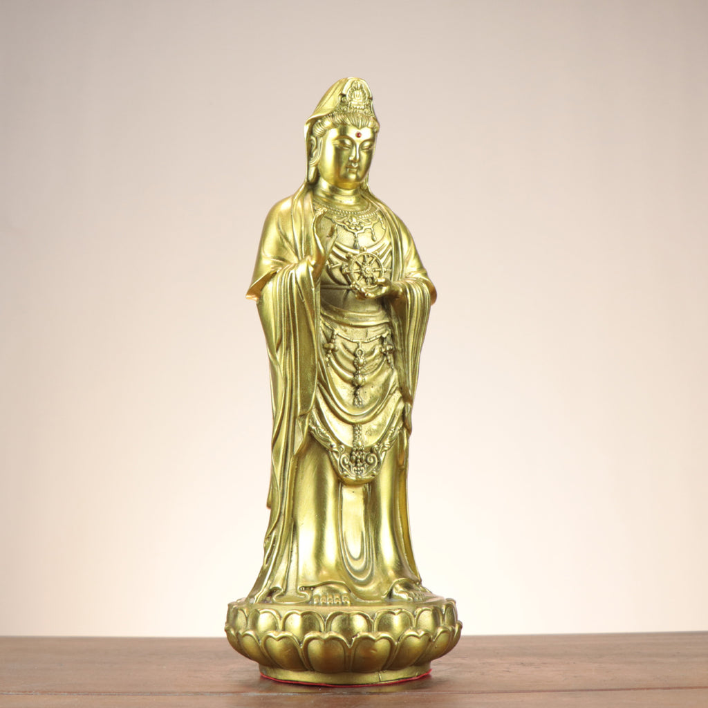 Three-quarter view of standing Guanyin Bodhisattva copperware statue holding a Dharma wheel on lotus base