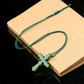 Polished stone cross pendant necklace in deep green with braided cord