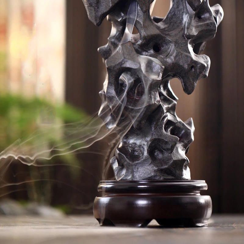 Incense smoke drifting through Taihu stone inspired ceramic openings