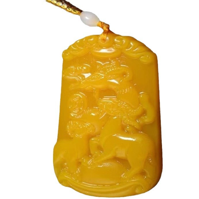 Three Goats Prosperity carved yellow stone pendant on white background
