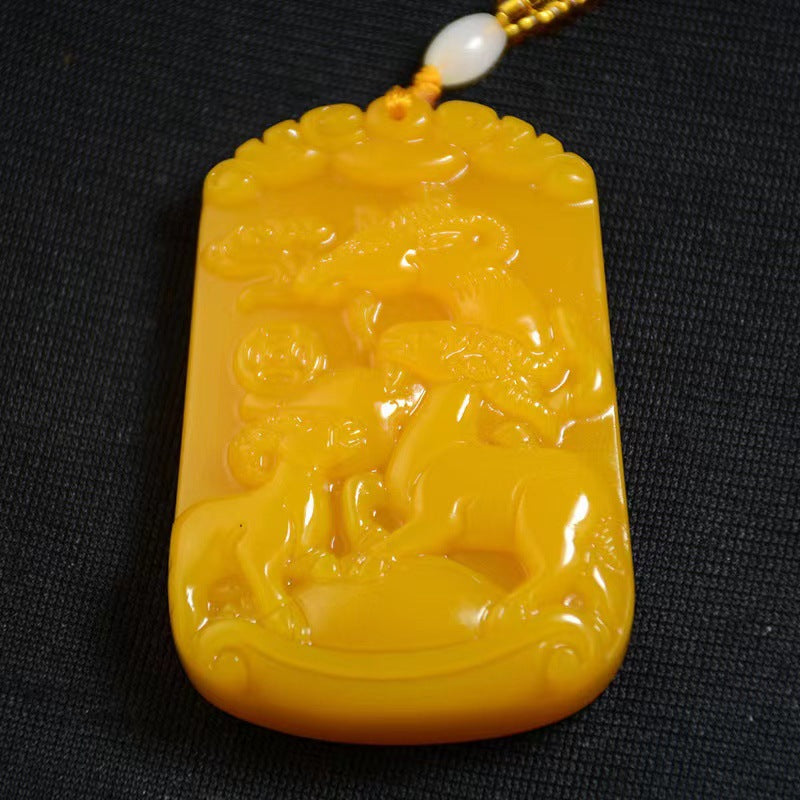 Golden yellow San Yang Kai Tai goat motif pendant close view