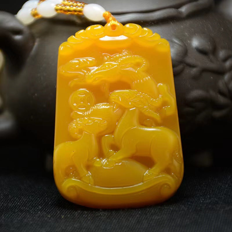 Golden yellow Three Goats carved plaque pendant detail