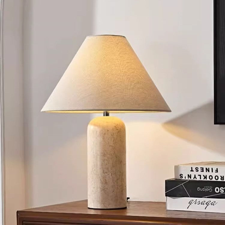 Travertine bedside table lamp with warm beige tapered shade