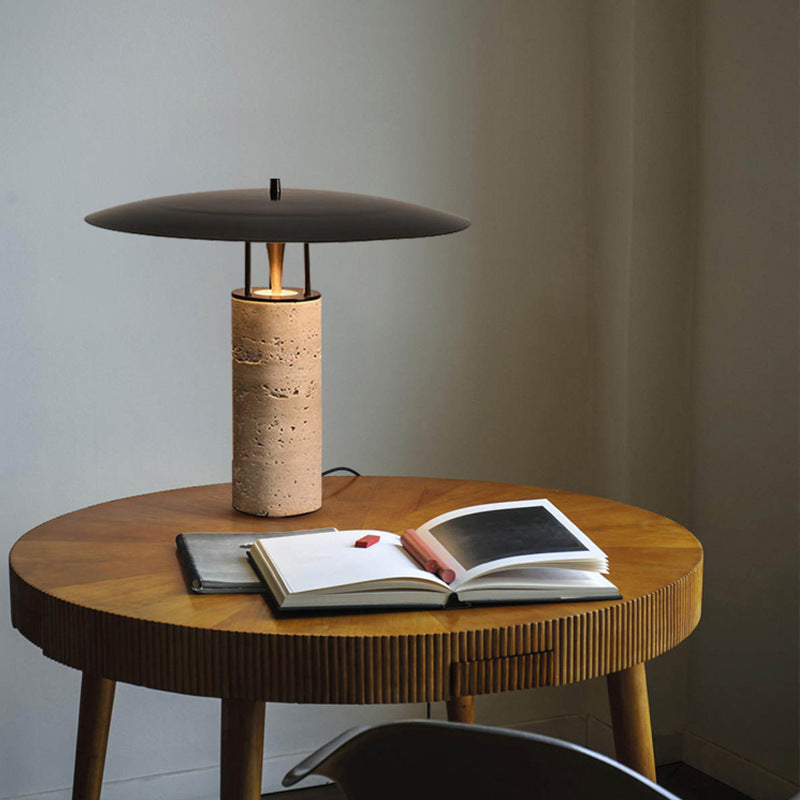Travertine column table lamp with black floating disc shade on dining table