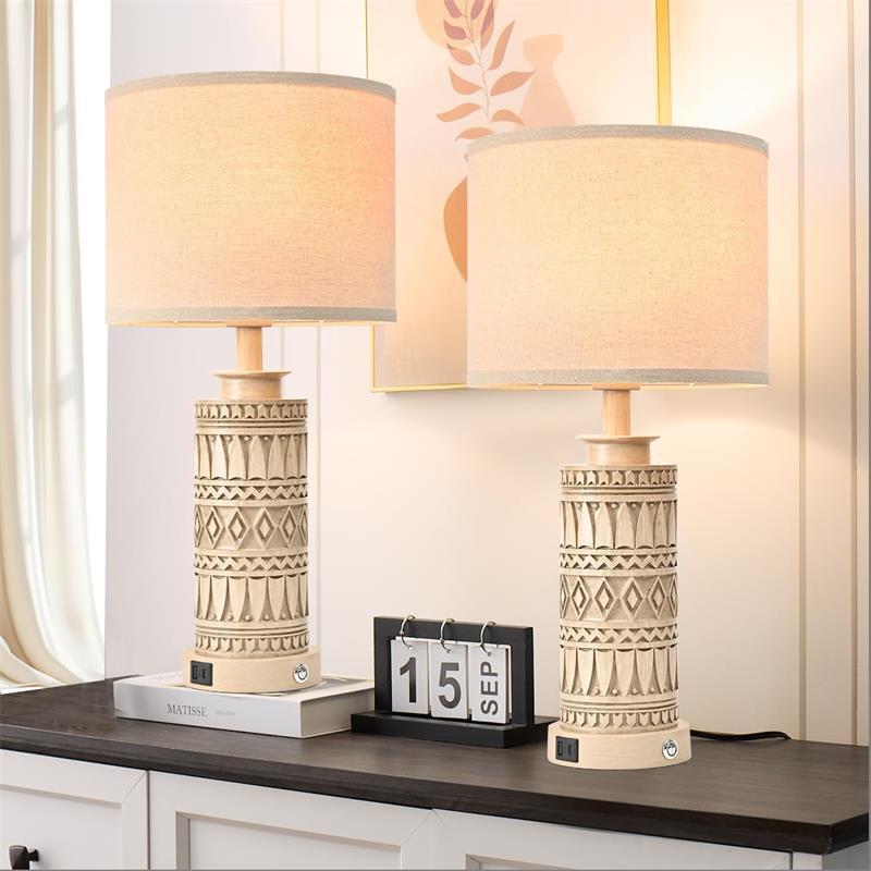Two tribal pattern table lamps on console with warm linen shades