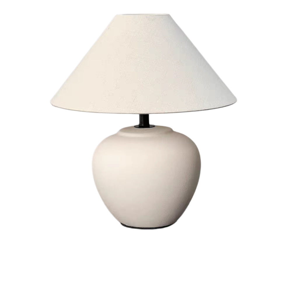Matte white rounded ceramic table lamp with linen cone shade for wabi-sabi interiors