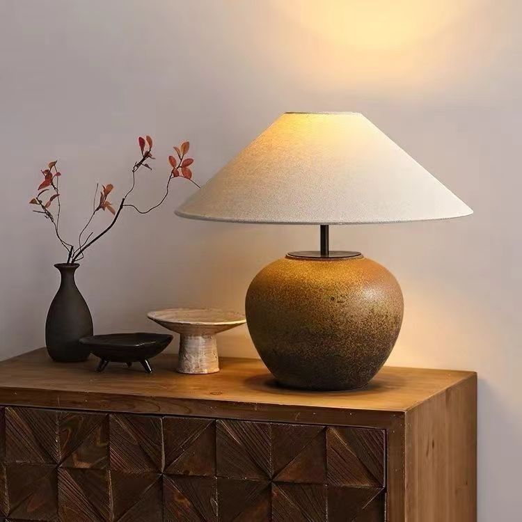 Matte white ceramic table lamp styled on a wood console