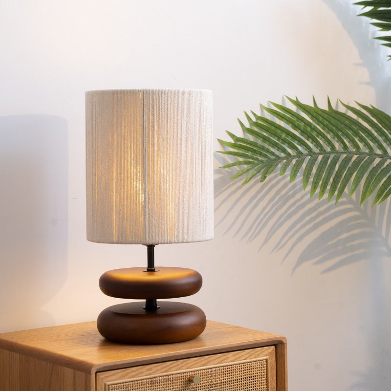 Walnut wood table lamp styled on a bedside table