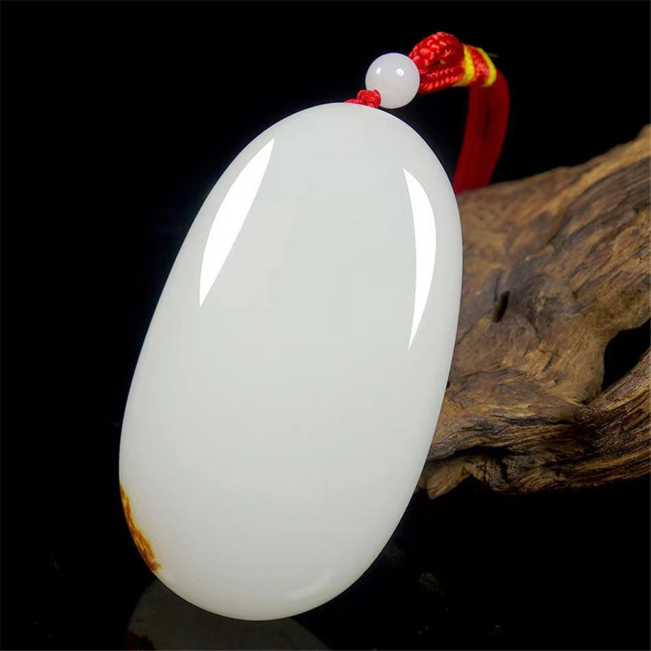 White calcite hand piece displayed against natural wood