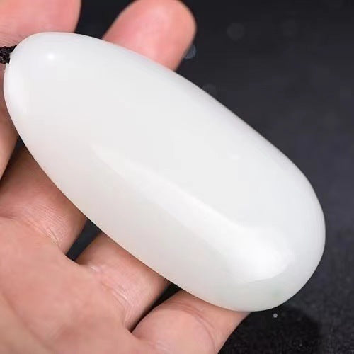White calcite palm stone side profile showing smooth rounded form