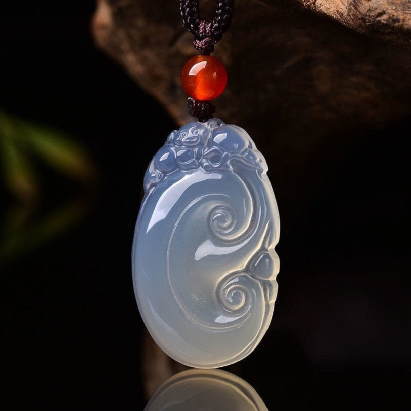 White chalcedony Ruyi pendant close-up with red bead