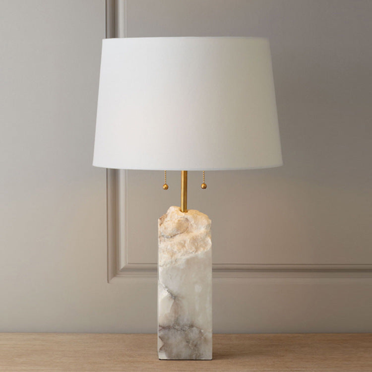 White cloud stone table lamp with linen drum shade on console