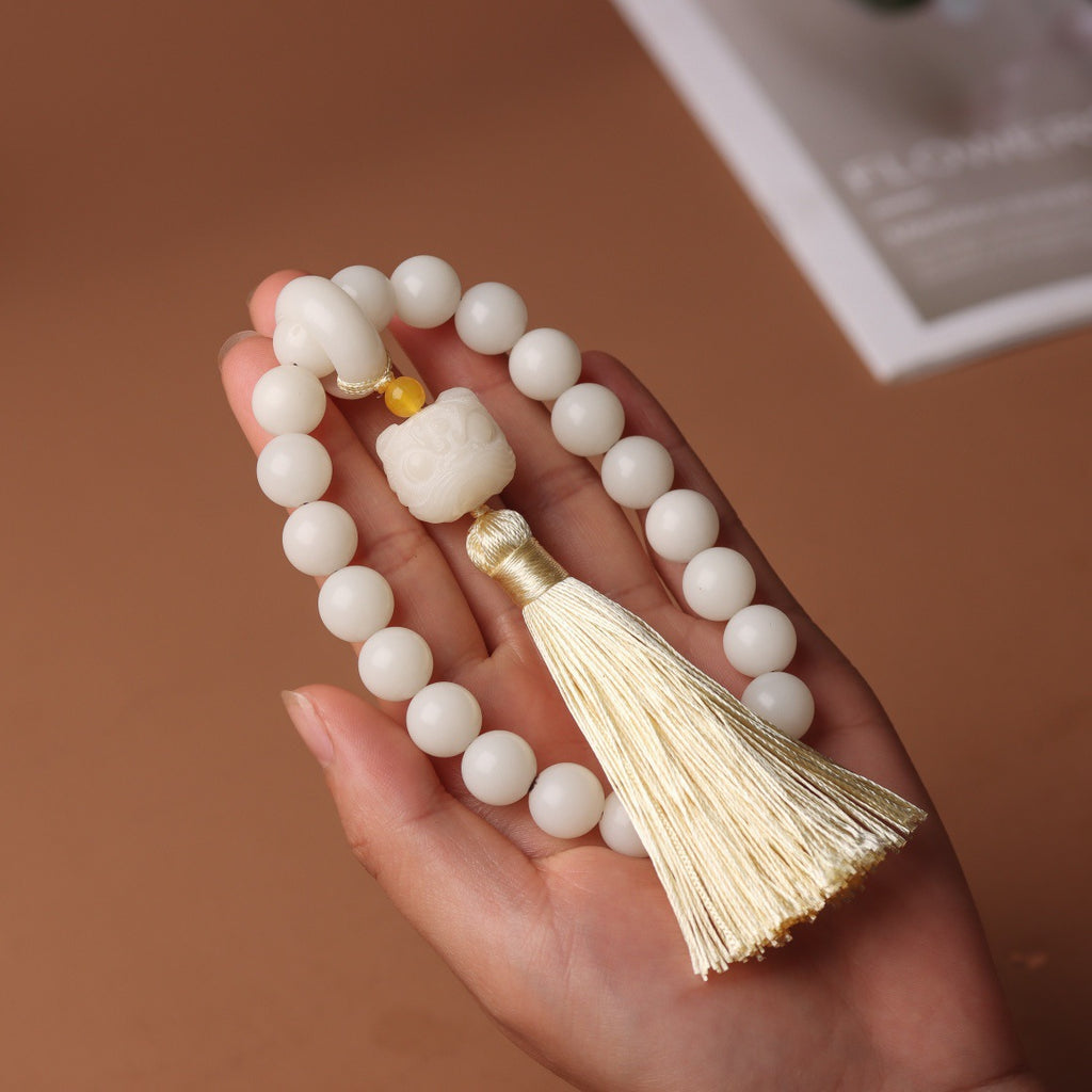 White Jade Bodhi-style 10mm hand mala with braided pouch-style focal detail and tassel