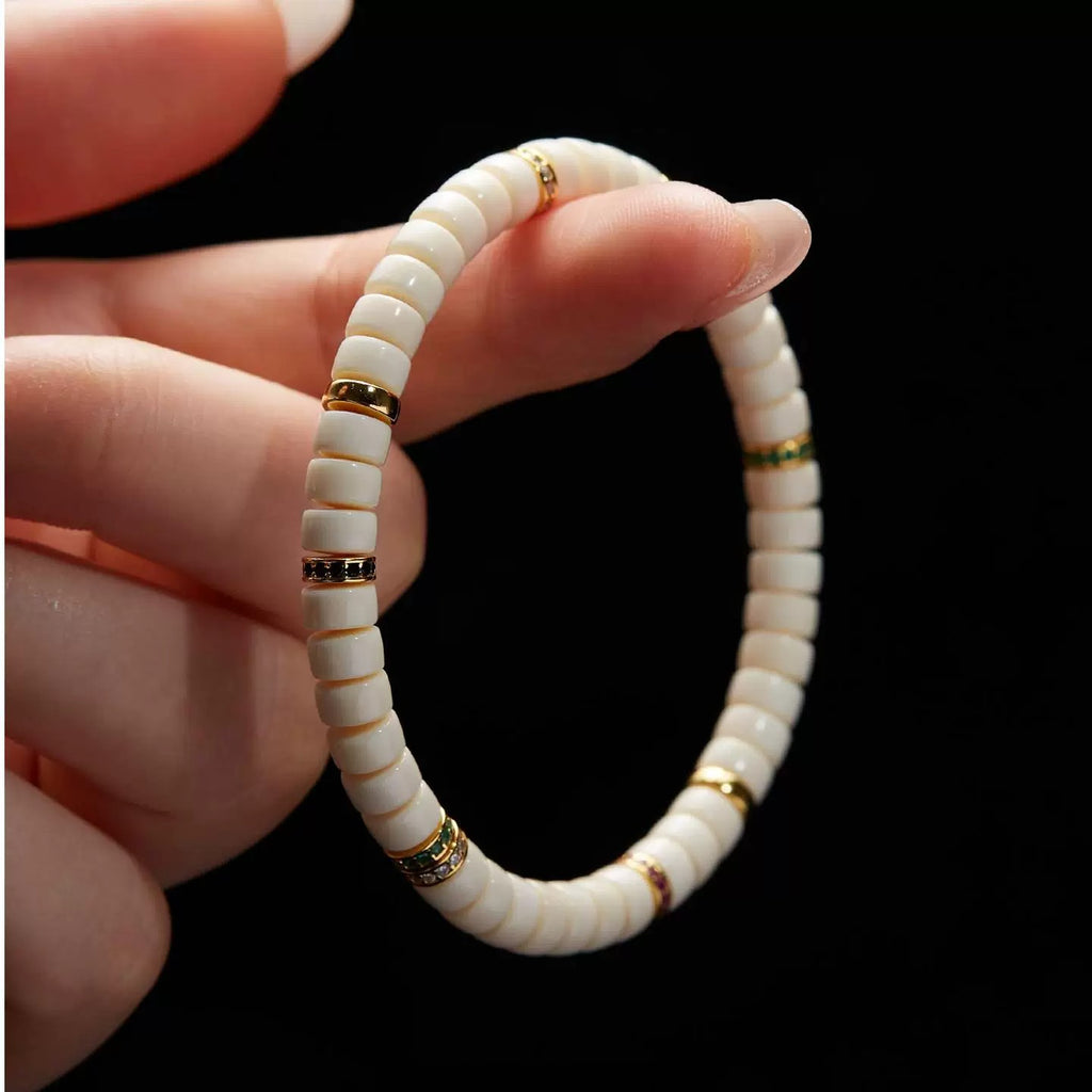 Close-up of White Jade Bodhi style flat disc beads and decorative spacer details