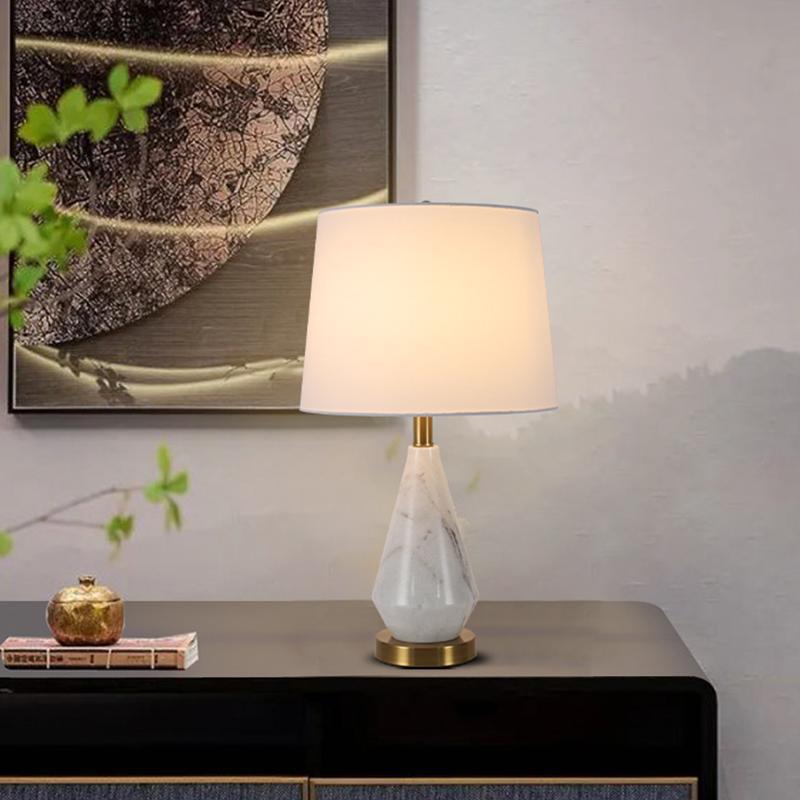 White marble designer table lamp on dark wood console