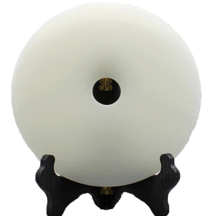 White peace buckle bi-disc style decor displayed on a black stand