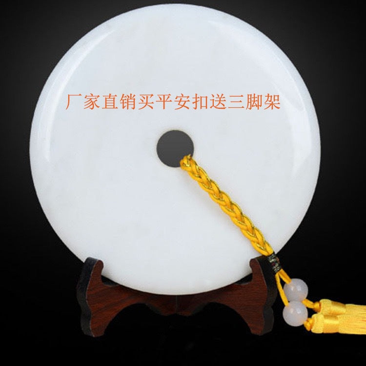 White peace buckle ornament with gold tassel on included display stand