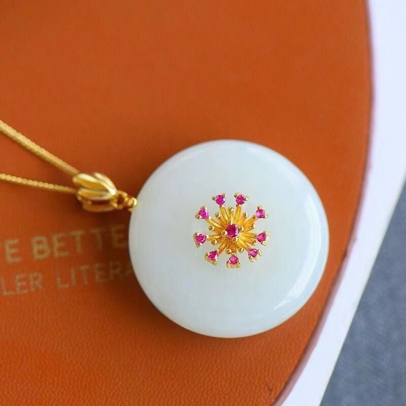 White peace buckle pendant with gold-tone halo and green center accent