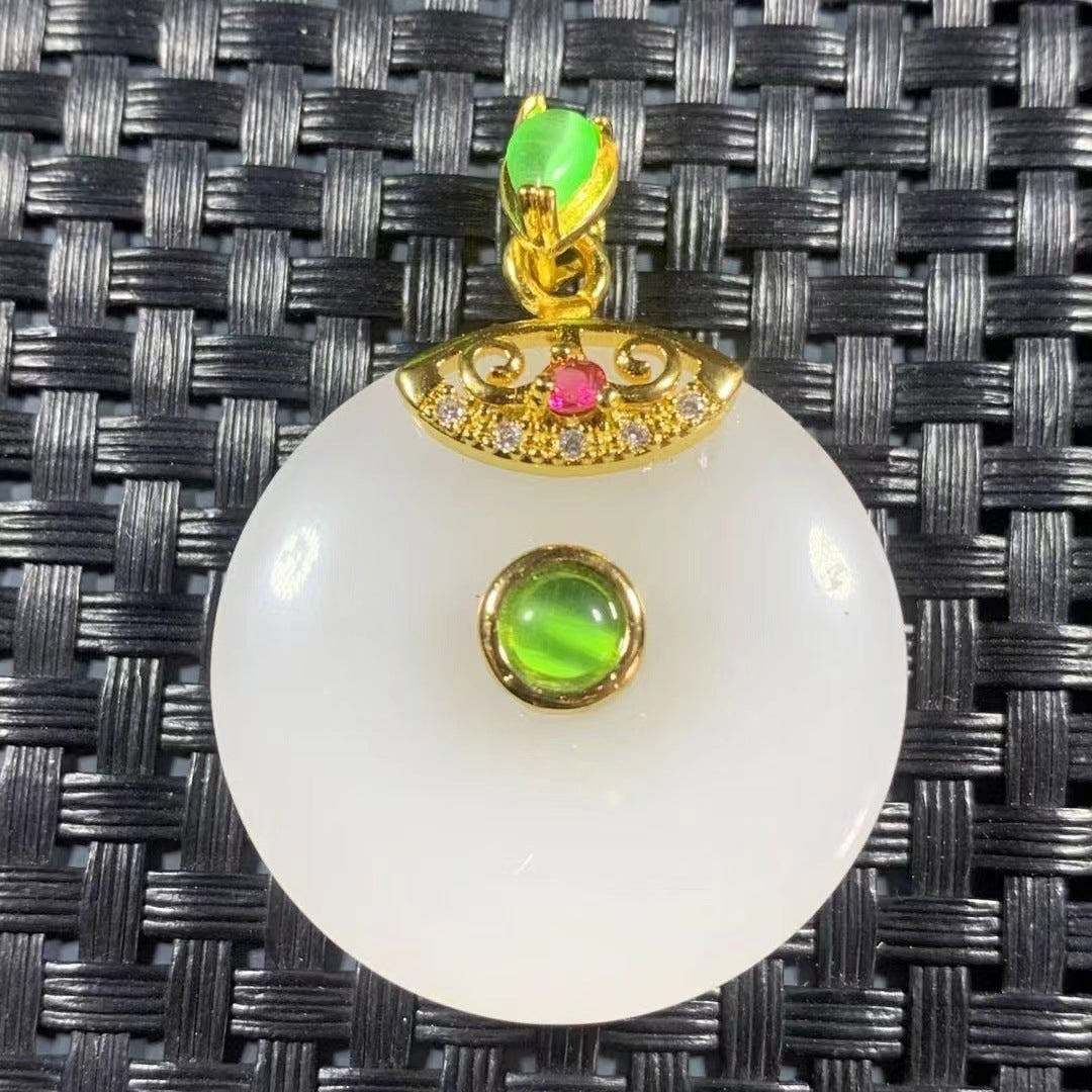 White peace buckle style pendant with green jewel-tone accent