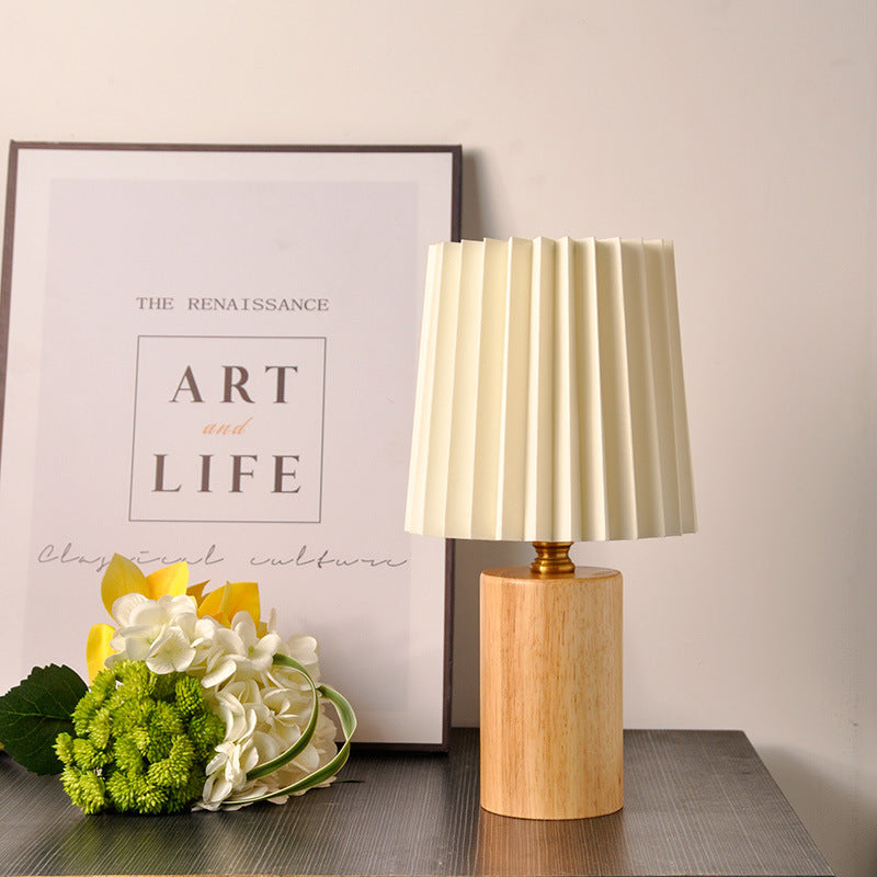 Natural wood cylinder bedside table lamp with ivory pleated shade