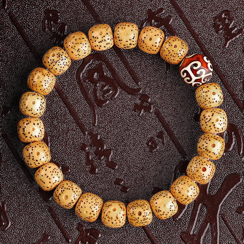 Golden Xingyue Bodhi seed bracelet with Tibetan-style mantra barrel accent bead
