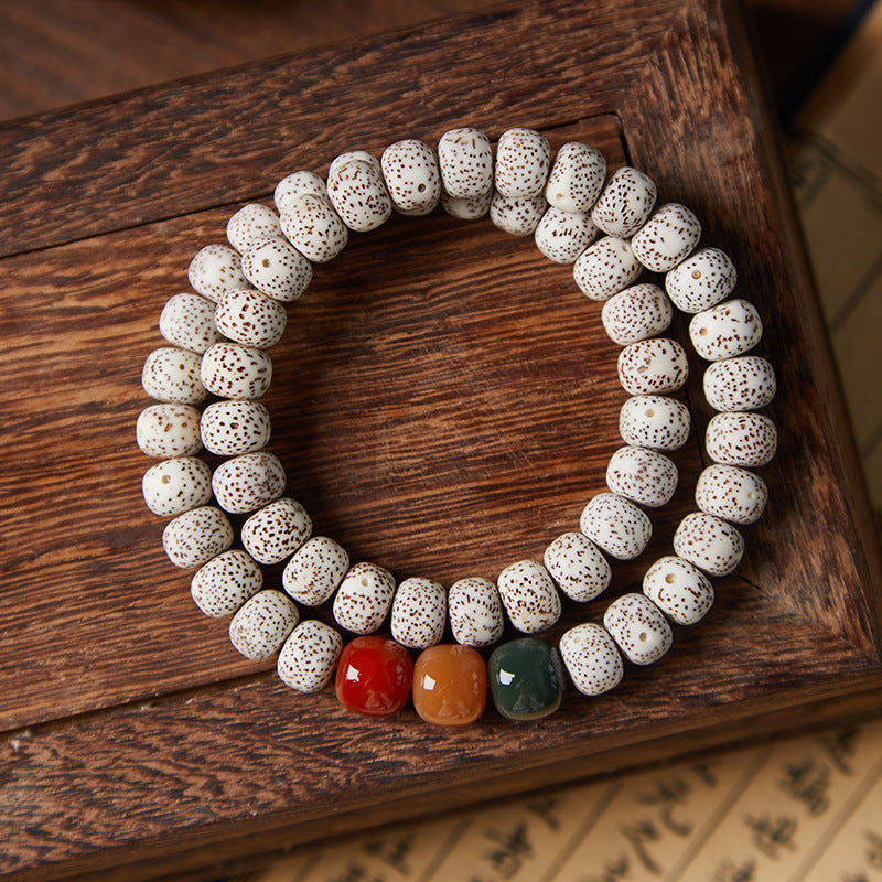 White Xingyue Bodhi seed double-wrap bracelet with red, amber-tone and dark green accent beads