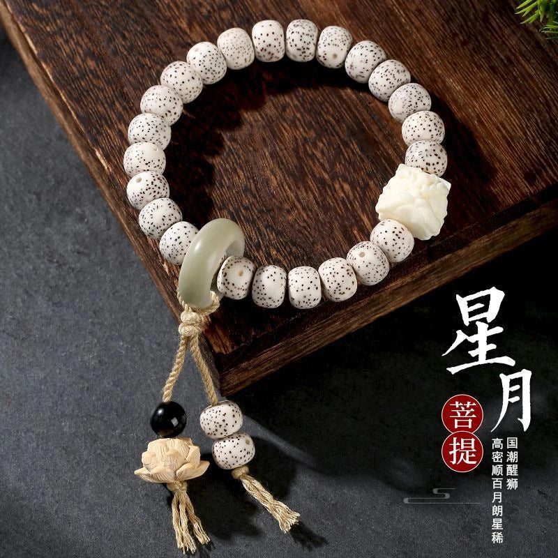 White Xingyue Bodhi seed bracelet with carved lotus, pale green ring accent and hanging tassel