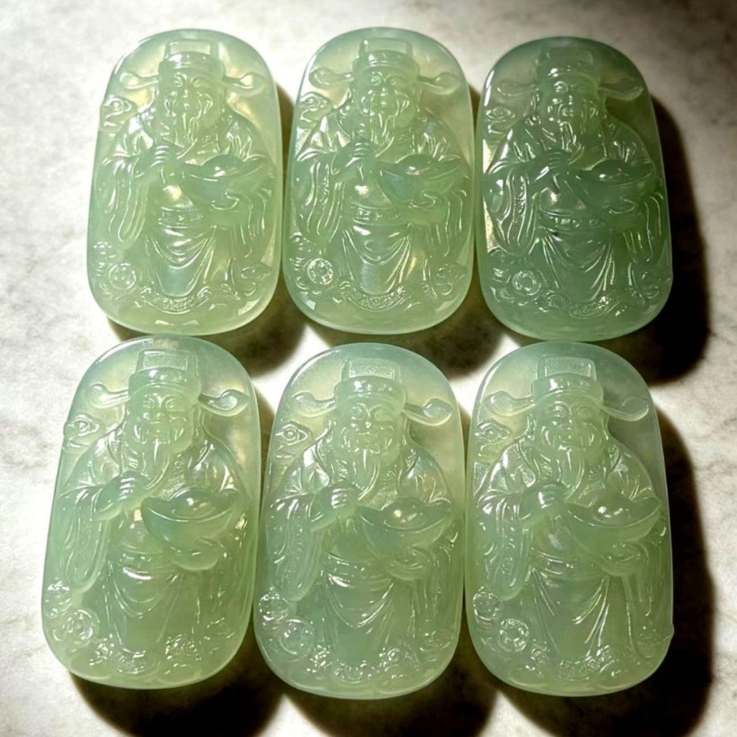 Xiuyan jade Wealth God plaques showing natural green tonal variation